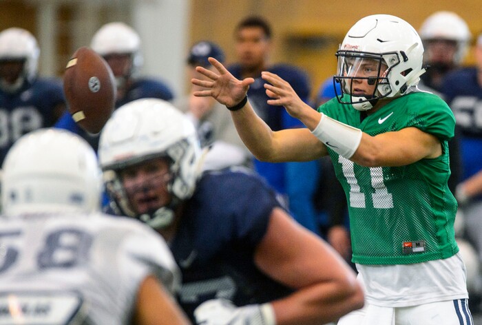 (Steve Griffin  |  The Salt Lake Tribune)  BYU quarterback Zach Wilson reaches for the snap during spring football practice for BYU in the indoor practice facility in Provo Thursday March 15, 2018.