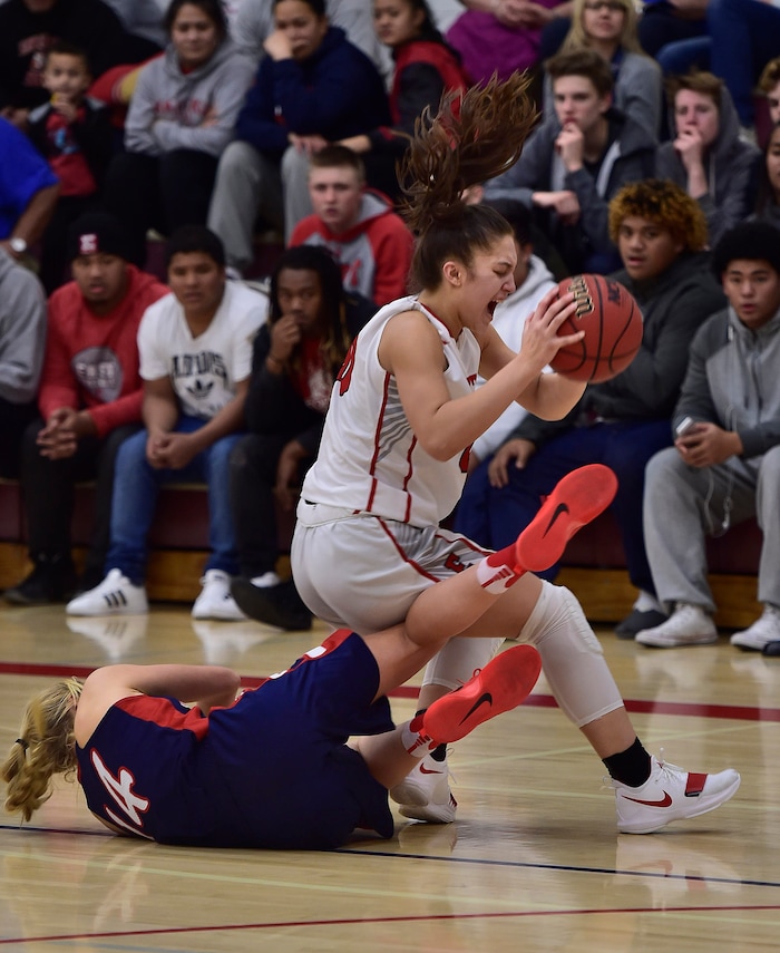 (Scott Sommerdorf   |  The Salt Lake Tribune)   East's are Falatea gets tangled up with Rachel Noel late in the game as East beat Woods Cross 50-36, Friday, December 15, 2017.  