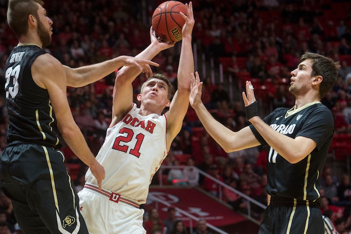 (Rick Egan  |  The Salt Lake Tribune)  Utah Utes forward Tyler Rawson (21) shoots as Colorado Buffaloes forward Lucas Siewert (23) and Colorado Buffaloes guard Lazar Nikolic (11) defend, in PAC-12 basketball action between Utah Utes and Colorado Buffaloes, at the Jon M. Huntsman Center, Saturday, March 3, 2018.