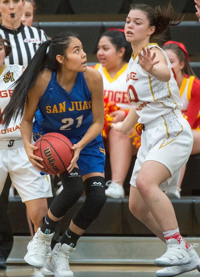 (Rick Egan  |  The Salt Lake Tribune)   Tasiah Little (21) San Juan, looks for a shot, as Victoria Garcia (40) defends for Judge Memorial, in 3A Women's basketball State playoff action Judge Memorial vs. San Juan, in Heber City, Friday, Feb. 16, 2018.