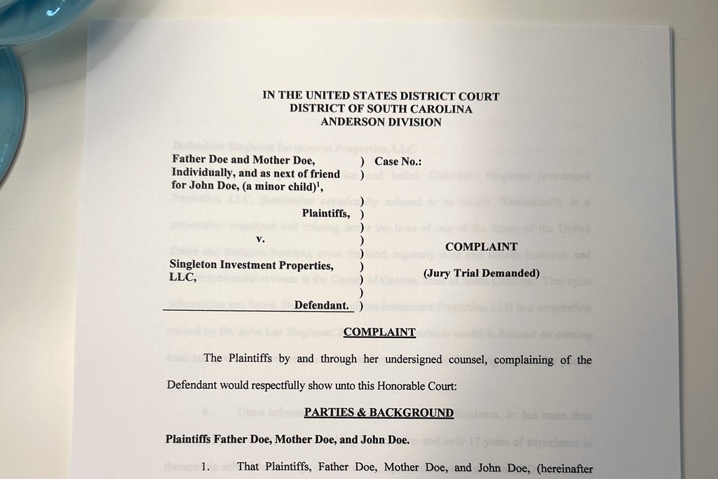 (Brynn Anderson | AP Photo) A lawsuit is seen on Thursday, July 27, 2023, in Atlanta. The parents of a teenager with special needs say he was repeatedly sexually assaulted and raped by an employee at the small private boarding school in South Carolina. They have sued the school's parent company, which has denied the allegations.