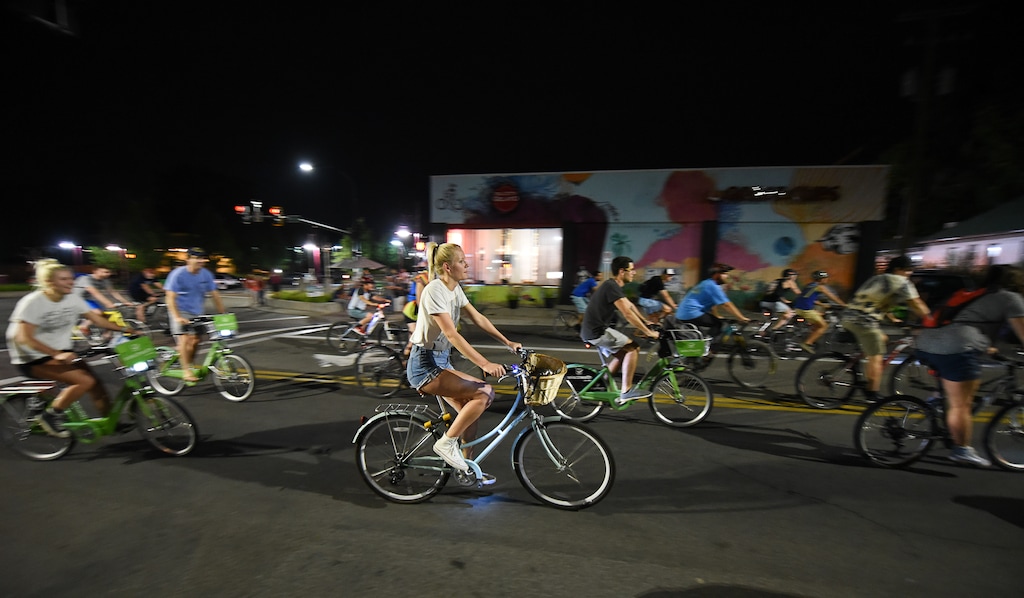 (Francisco Kjolseth  |  The Salt Lake Tribune)  A large group of cyclist begins their ride from the corner of 9th and 9th after gathering after 9pm in Salt Lake City on Thursday, July 26, 2018, for the weekly ride that has become known as the 999 Ride. The inclusive, all-welcoming slow casual social ride happens year round on Thursday nights, with riders often pedaling into the early morning hours. Newly released video shows rider Cameron Hooyer being struck and killed by a FrontRunner train at a downtown railroad crossing during last weeks ride when the 22-year-old failed to stop or heed the warning signals before crossing the tracks during the group ride. 