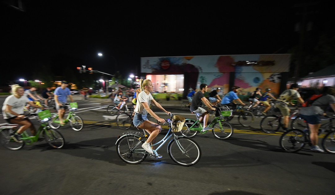 (Francisco Kjolseth  |  The Salt Lake Tribune)  A large group of cyclist begins their ride from the corner of 9th and 9th after gathering after 9pm in Salt Lake City on Thursday, July 26, 2018, for the weekly ride that has become known as the 999 Ride. The inclusive, all-welcoming slow casual social ride happens year round on Thursday nights, with riders often pedaling into the early morning hours. Newly released video shows rider Cameron Hooyer being struck and killed by a FrontRunner train at a downtown railroad crossing during last weeks ride when the 22-year-old failed to stop or heed the warning signals before crossing the tracks during the group ride. 