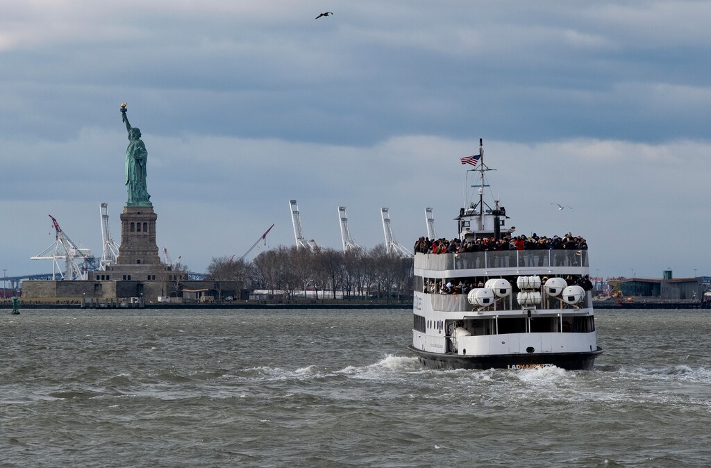 (Craig Ruttle | The Associated Press) A ferry full of passengers steams towards the Statue of Liberty Saturday, Dec. 22, 2018, in New York. The national landmark remained open despite a partial government shutdown after New York Governor Andrew Cuomo made funding available to keep the monument open.