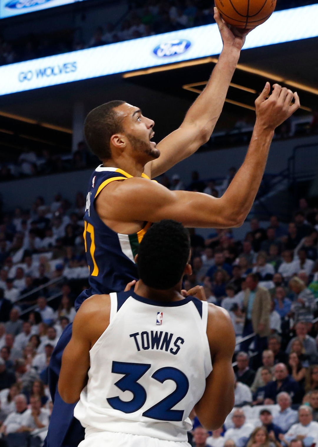 Utah Jazz's Rudy Gobert, top, of France, lays up as Minnesota Timberwolves' Karl-Anthony Towns looks on during the first half of an NBA basketball game Friday, Oct. 20, 2017, in Minneapolis. AP Photo/Jim Mone)
