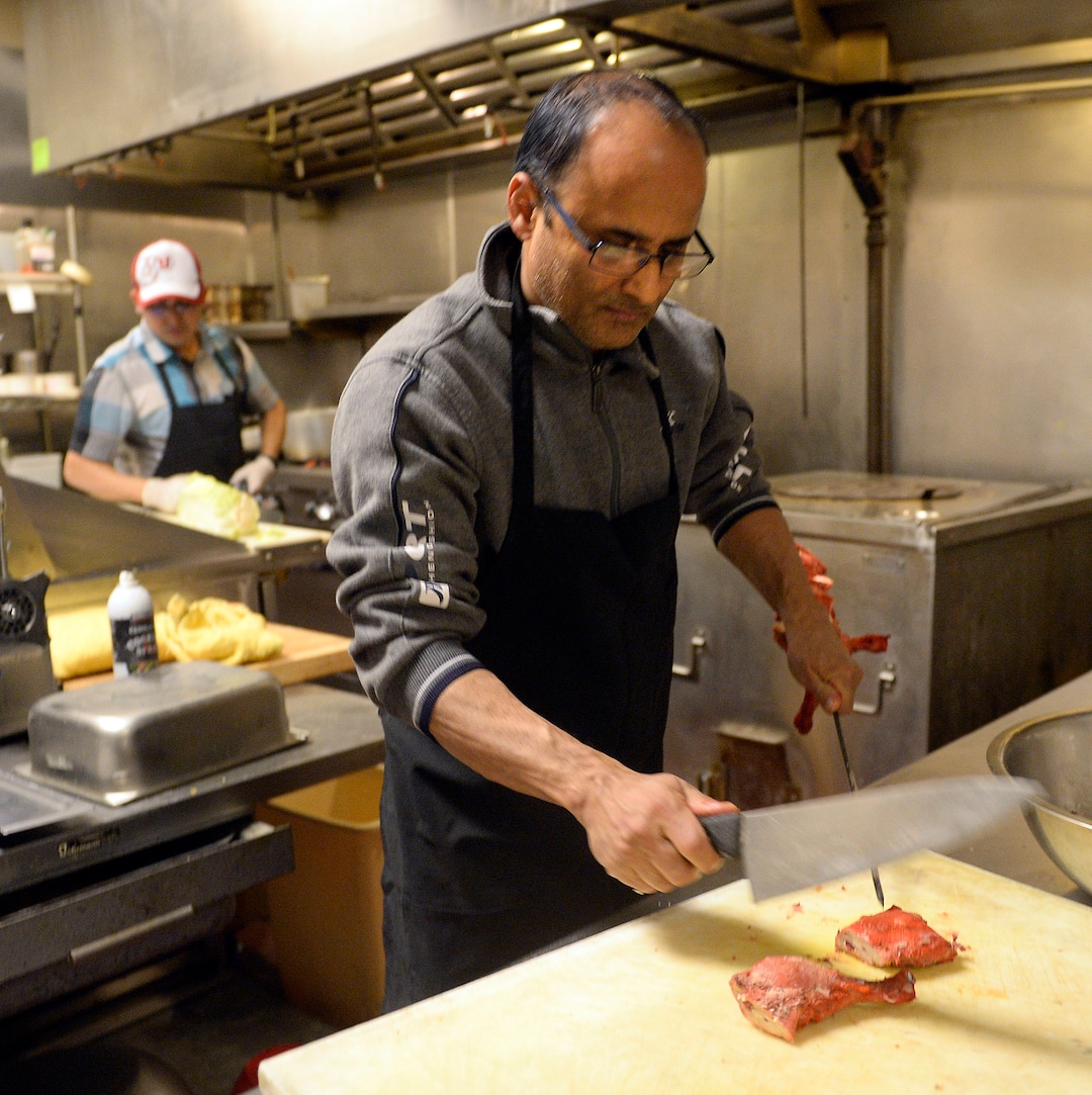 (Al Hartmann  |  The Salt Lake Tribune) 	
Kamal Niroula prepares chicken for recently opened Bhutan House, in Sandy. Kamal and his wife, Geeta, moved to Utah with their three children in 2010. Originally from Bhutan, they lived in Nepal before their resettlement in the United States.  The couple participated in the Spice Kitchen Incubator program, initially catering and doing special events before opening their own restaurant, which serves foods from Bhutan, Nepal and India.