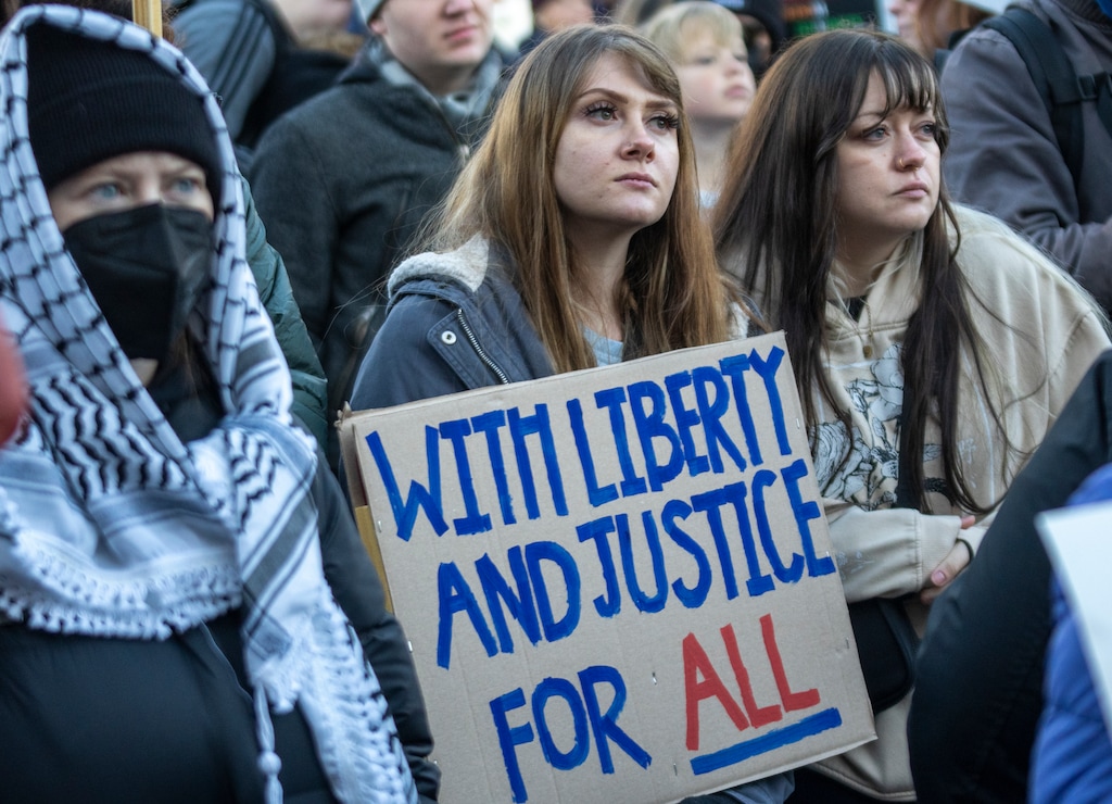 (Rick Egan | The Salt Lake Tribune) People hold signs and listen to speakers at a protest against federal immigration actions in Salt Lake City on Sunday, Jan 25, 2026.