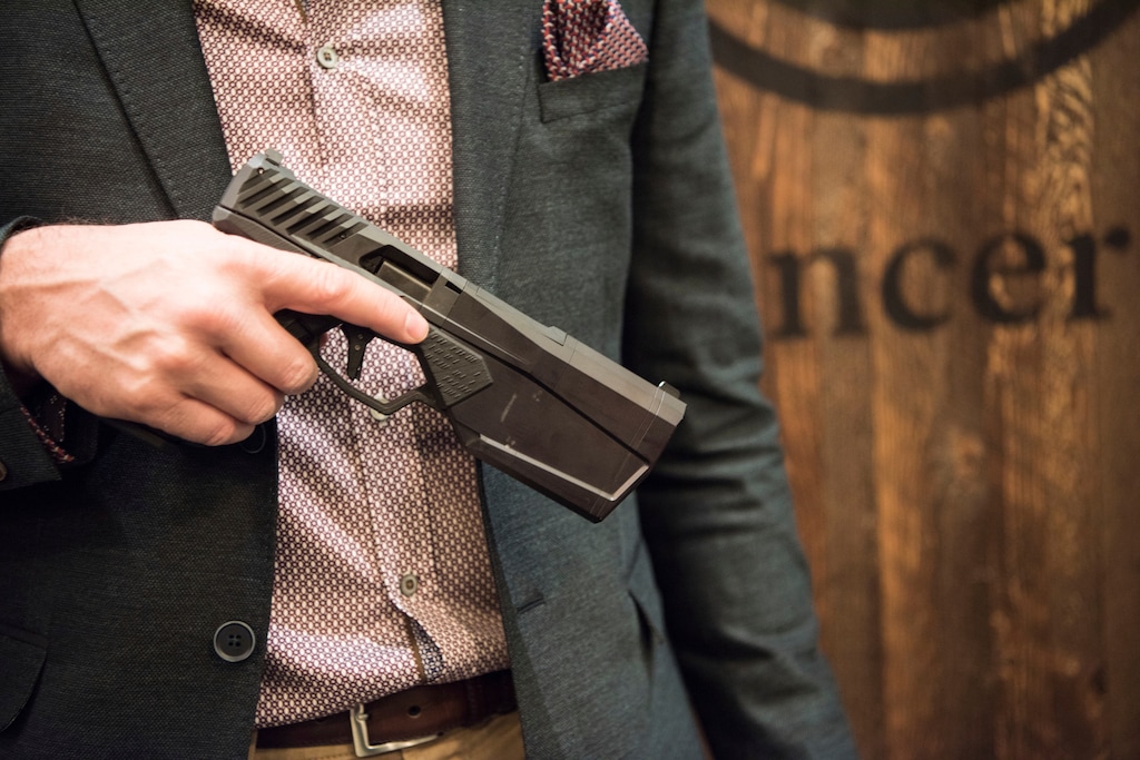 In this photo taken Jan. 17, 2017, Josh Waldron, co-founder and CEO of SilencerCo, holds one of his company's Maxim 9 products, holds a 9mm handgun, in Las Vegas, in which the suppressor is embedded into the barrel. They are the stuff of legend, wielded by hit men and by James Bond. For decades, buying a silencer for a firearm has been as difficult as buying a machine gun, requiring a background check that can take close to a year. Now, emboldened by the election of Donald Trump as president, the industry has renewed a push in Congress to ease those restrictions, arguing that it’ll help preserve the hearing of gun users. (AP Photo/Lisa Marie Pane)