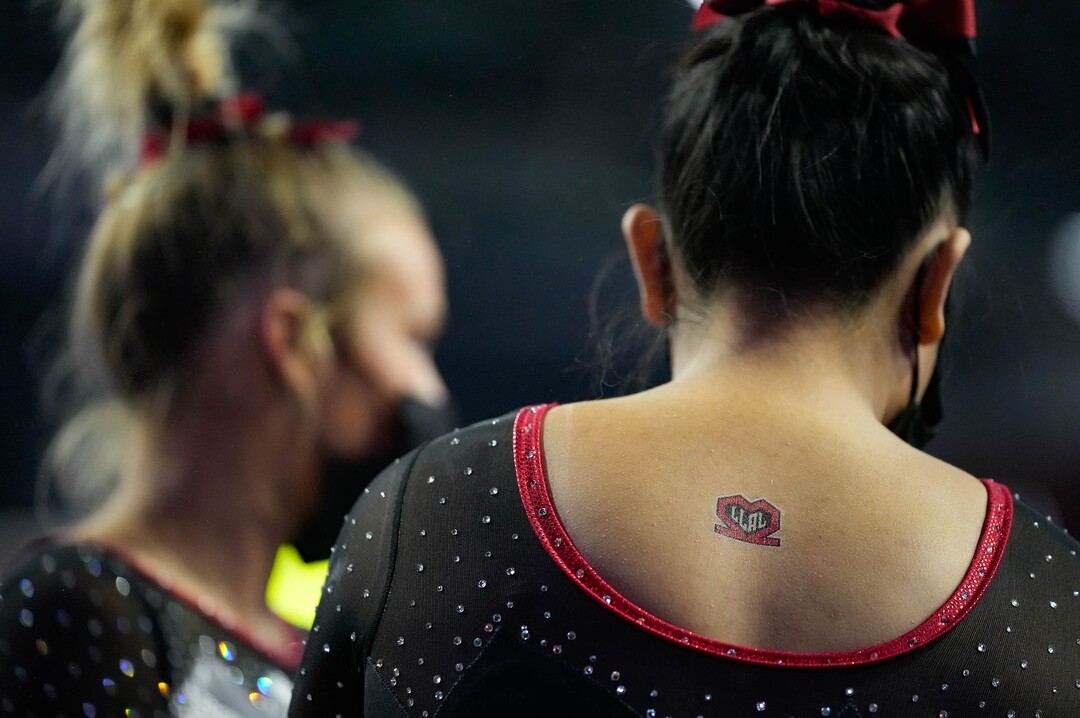 (Francisco Kjolseth | The Salt Lake Tribune) Utah gymnasts honor the memory of football players Ty Jordan and Aaron Lowe at the Best of Utah NCAA Gymnastics Meet at the Maverik Center in West Valley City on Friday, Jan. 7, 2022.