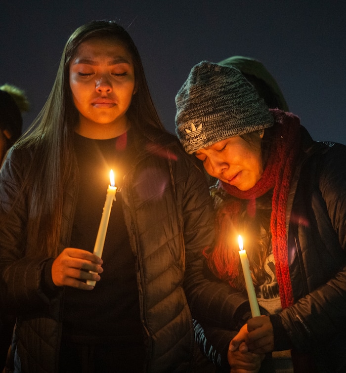 (Rick Egan  |  The Salt Lake Tribune)      Dion and Erin Tapahe hold hands as they listen to a song during a candlelight vigil on BYU campus, for the student who died by suicide this week, at the Tanner Building, Friday, Dec. 7, 2018.
  
