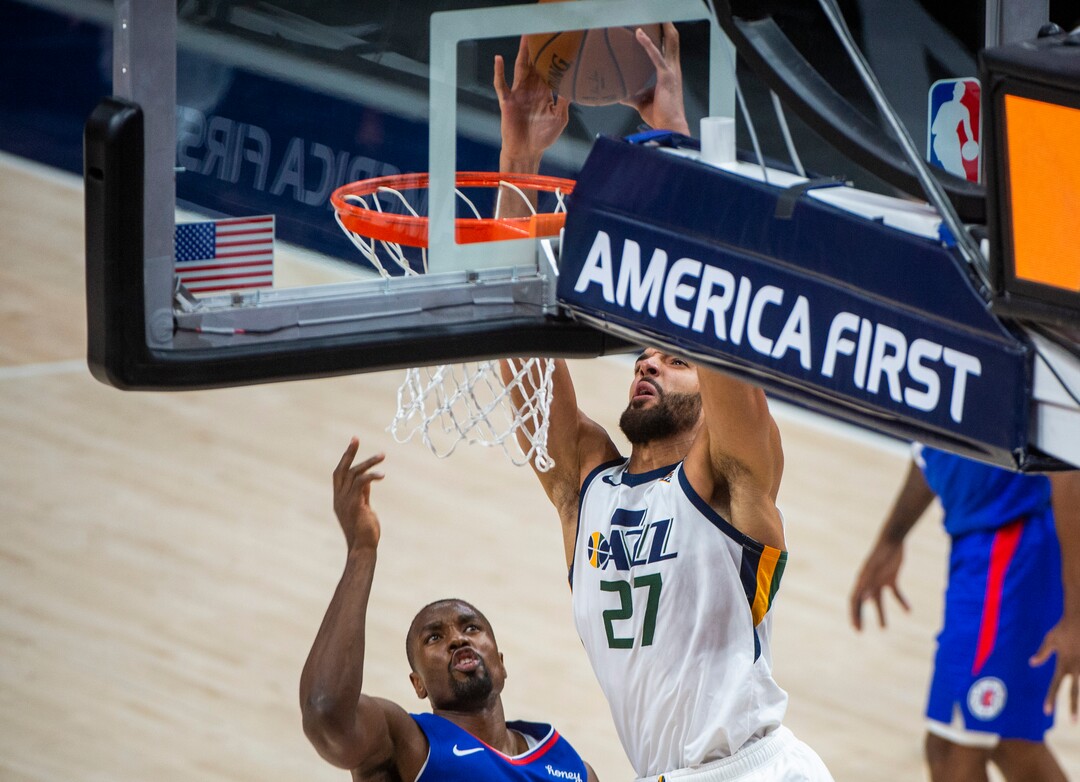 (Rick Egan | The Salt Lake Tribune) Utah Jazz center Rudy Gobert (27) dunks over LA Clippers forward Serge Ibaka (9), in NBA action between the Utah Jazz and the LA Clippers at Vivint Arena, on Friday, Jan. 1, 2021.