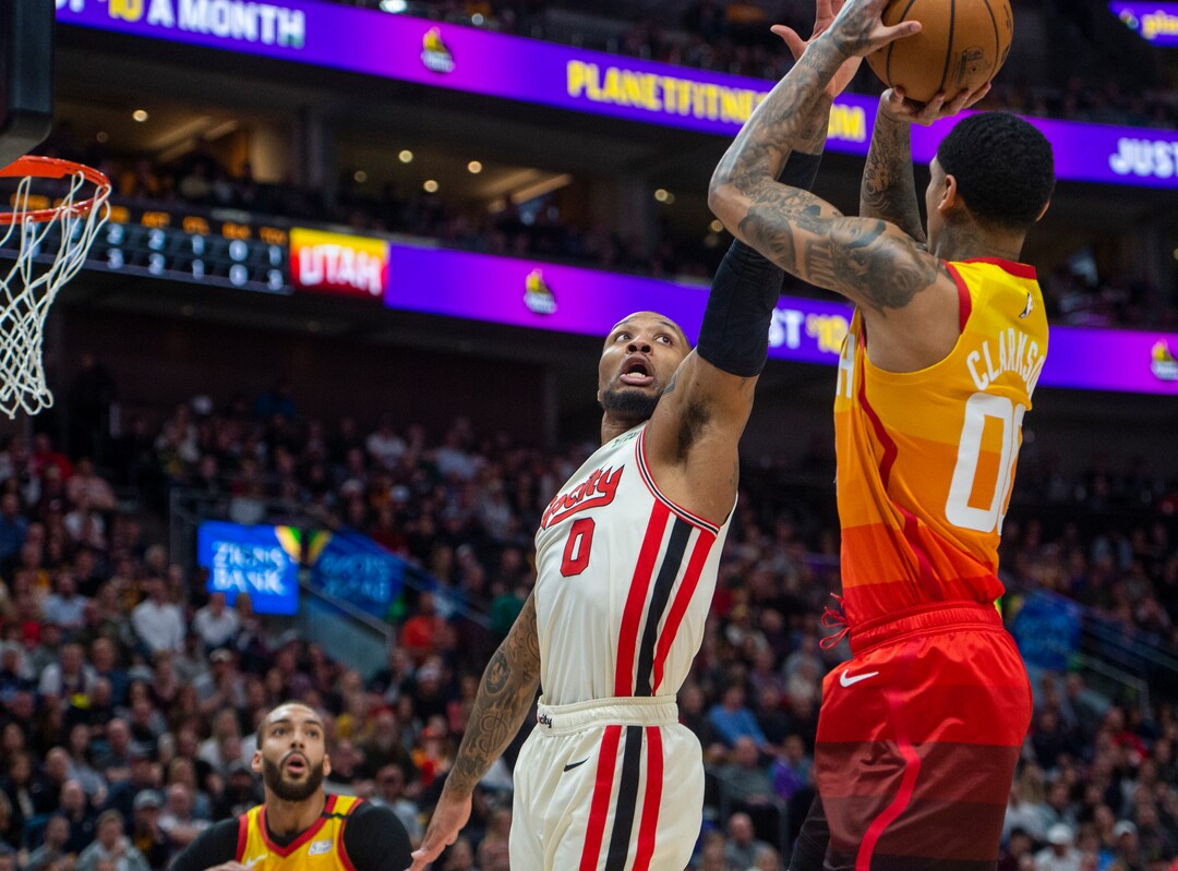 (Rick Egan  |  The Salt Lake Tribune)     Utah Jazz guard Jordan Clarkson (00) shoots over Portland Trail Blazers guard Damian Lillard (0) in NBA action between the Utah Jazz and the Portland Trail Blazers in Salt Lake City, Friday, Feb. 7, 2020.