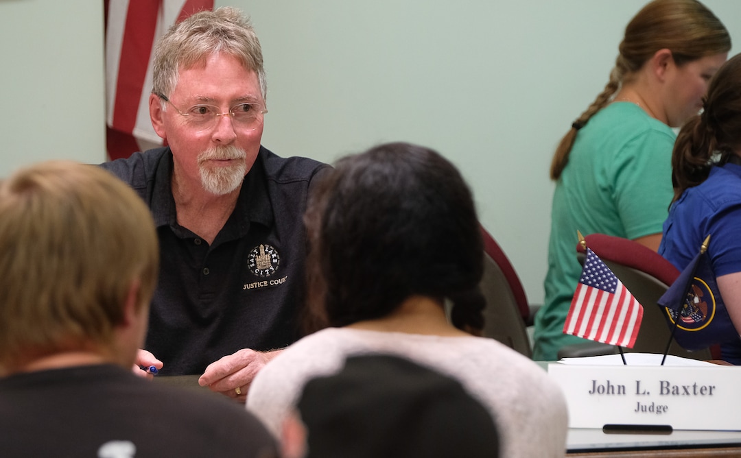 (Francisco Kjolseth  |  The Salt Lake Tribune)  Judge John L. Baxter speaks with a defendant during court held for homeless or transient people in the Weigand Center in Salt Lake City, June 28, 2019. Since May 2004, Salt Lake City has operated a homeless court, where transients can handle misdemeanor charges without showing up in regular court. This helps the homeless person by clearing outstanding warrants they have in a less intimidating environment and it also benefits the regular court by reducing its backlog of such cases. It's part of a larger effort on the part of the American Bar Association to decriminalize homelessness.