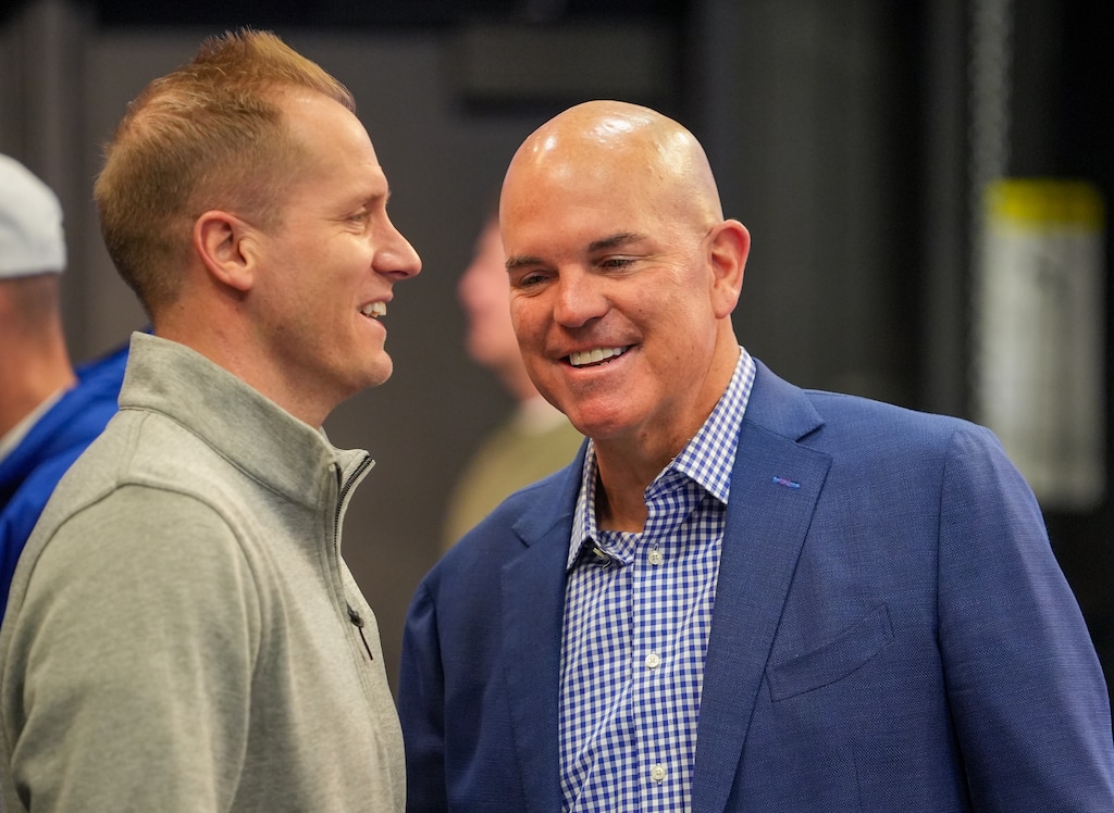 (Chris Samuels | The Salt Lake Tribune) BYU men’s basketball head coach Kevin Young, left, and deputy athletics director Brian Santiago converse before a news conference in Provo, Wednesday, Feb. 12, 2025, announcing athletics director Tom Holmoe’s retirement after 20 years at the school.