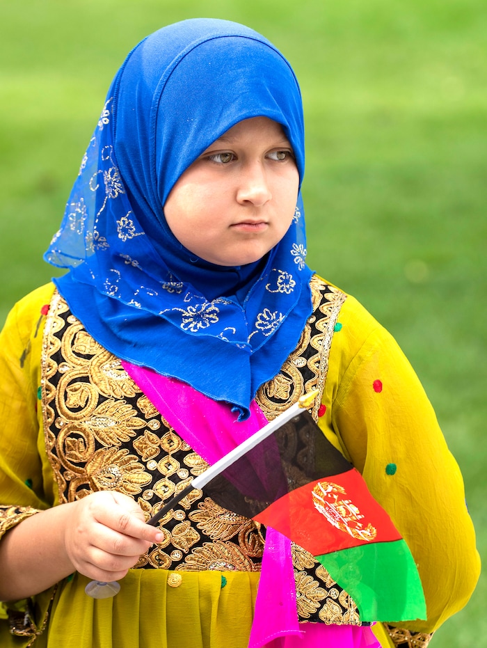 (Rick Egan | The Salt Lake Tribune) 
Arya Mustafawi holds an Afghan flag at Murray Park during a prayer vigil in honor of Utah’s Afghan refugees, onSaturday, Aug. 21, 2021.