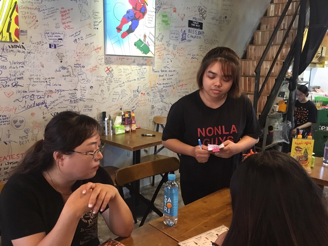 (Matilyn Mortensen | Special to The Tribune) A server takes orders at Nonla Guys restaurant in Ho Chi Mihn City in Vietnam. The restaurant's founders were inspired to start their business by a 2016 documentary on the rebirth of Korean comfort food in the United States, and its segment on the creators of Cupbop in Salt Lake City.