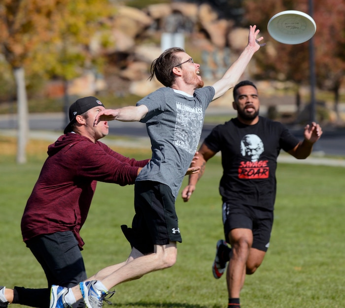 (Steve Griffin  |  The Salt Lake Tribune)  Richard Chrtiansen, a support manager for Xima Software, knocks a pass away as fellow employees play a game of Ultimate Frisbee during lunchtime on River Front Parkway in South Jordan Friday October 13, 2017.