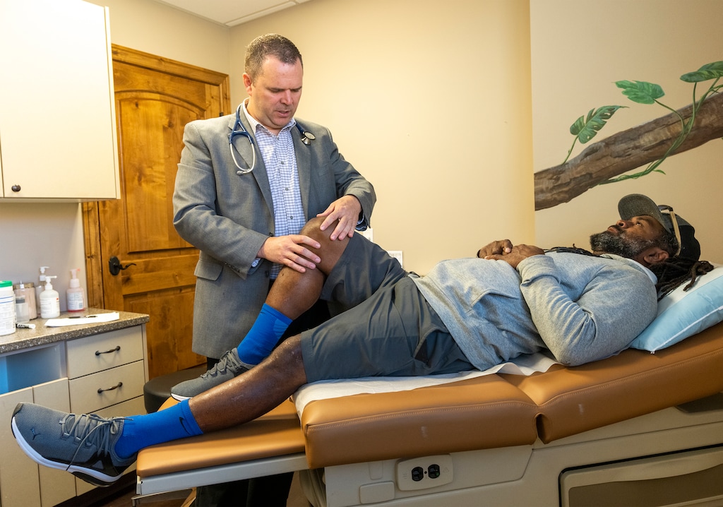 (Rick Egan | The Salt Lake Tribune)  Dr. Kevin Mangum examines patient Obetaia Babakobau at his Murray clinic, Primary Healthcare, on Friday, Aug. 4, 2023. Mangum said he left a larger health care system to start his own practice and to better manage appointment wait times for patients.