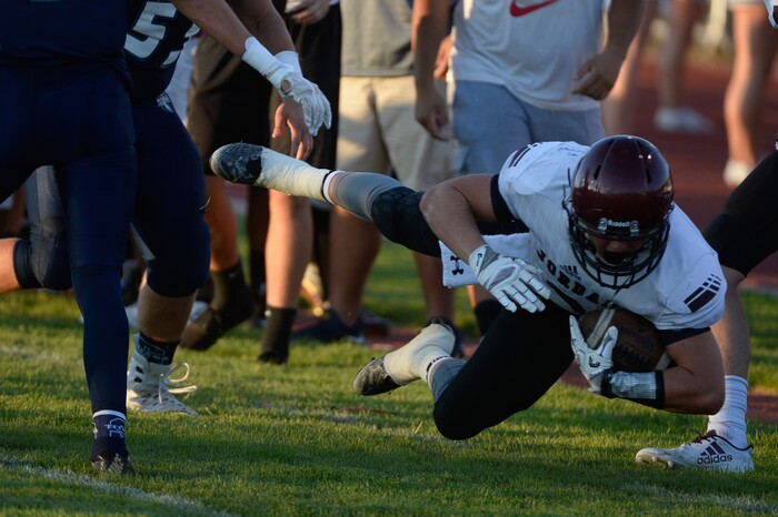 (Francisco Kjolseth  |  The Salt Lake Tribune)  Jacob Shaver of Jordan is tackled on the sidelines by the Syracuse defense in game action at Syracuse on Thursday, Aug. 24, 2017.