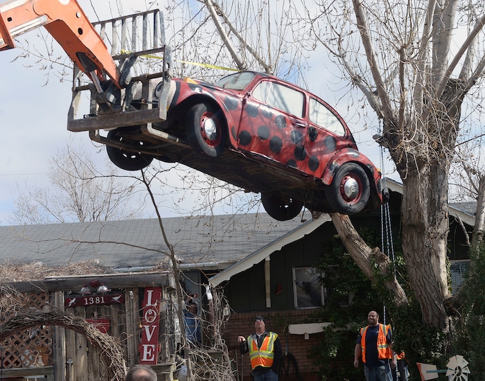 (Al Hartmann | The Salt Lake Tribune)
Clearfield public works personnel use a crane to remove Janis Zettel's gutted VW Beetle from a tree in her front yard Tuesday Feb. 13. She put it up a few months ago as an art installation. Now it has to come down.