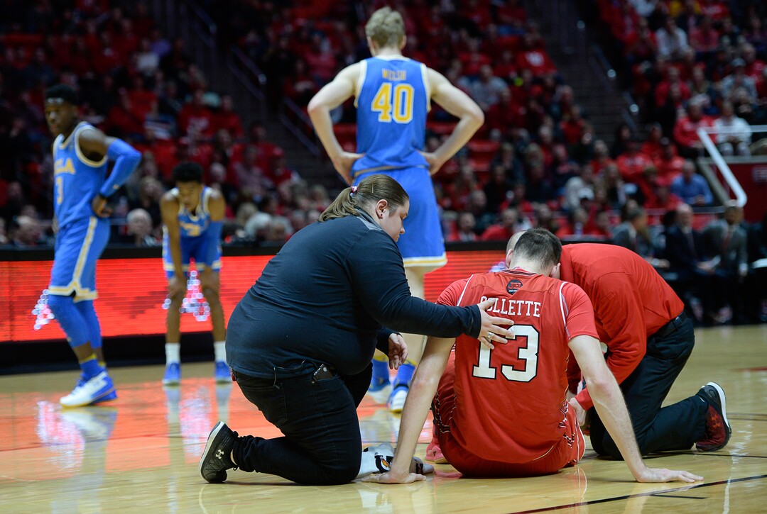 (Francisco Kjolseth  |  The Salt Lake Tribune)  Utah Utes forward David Collette (13) injures his leg as the University of Utah hosts UCLA in NCAA basketball at the Huntsman Center in Salt Lake City, Thursday, Feb. 22, 2018.