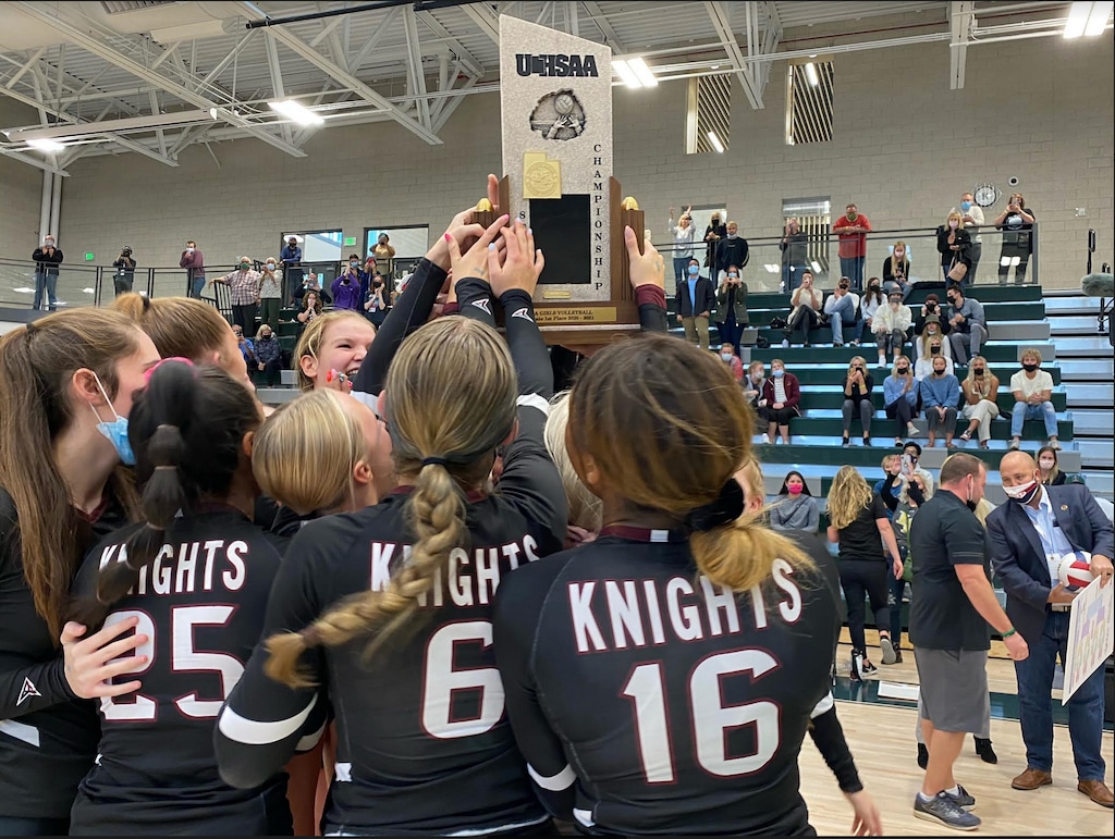 (Alex Vejar | The Salt Lake Tribune) Lone Peak players celebratye with their trophy after winning the 6A volleyball championship, holding off Copper Hills in four sets.