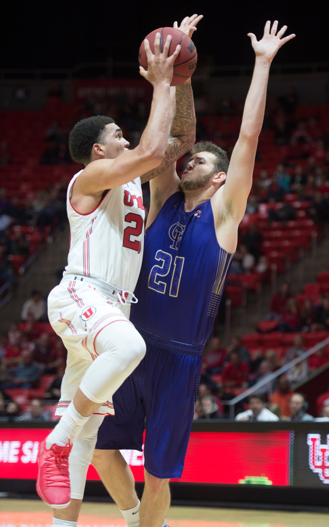 (Rick Egan  |  The Salt Lake Tribune)    Utah Utes forward Timmy Allen (20) shoots, as College of Idaho forward Connor Desaulniers (21) defends, in basketball action, between the Utah Utes and the College of Idaho Yotes at the Jon M. Huntsman Center, Thursday, Nov. 1, 2018.
