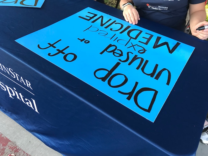 (Courtney Tanner | The Salt Lake Tribune) St. Mark's Hospital volunteers make posters for an opioid and prescription medication drop off event on Saturday, Sept. 7, 2019.