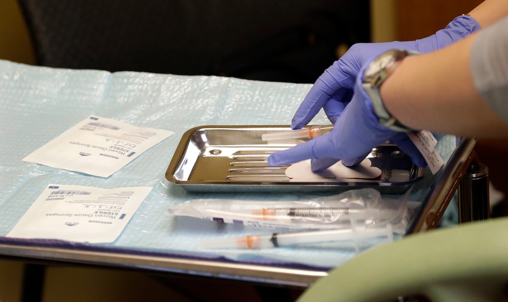 (Elaine Thompson | AP file photo)  A health care worker prepares syringes, including a vaccine for measles, mumps, and rubella (MMR), for a child's inoculations at the International Community Health Services in Seattle on Feb. 13, 2019.