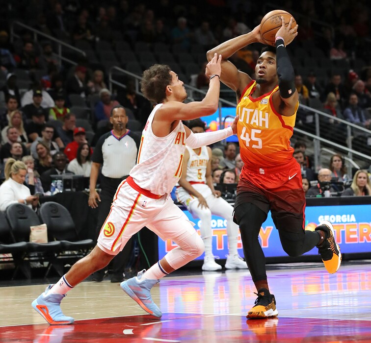 ((Curtis Compton | Atlanta Journal-Constitution via AP) Atlanta Hawks guard Trae Young, left, defends against Utah Jazz guard Donovan Mitchell during the first half of an NBA basketball game Thursday, Dec. 19, 2019, in Atlanta.