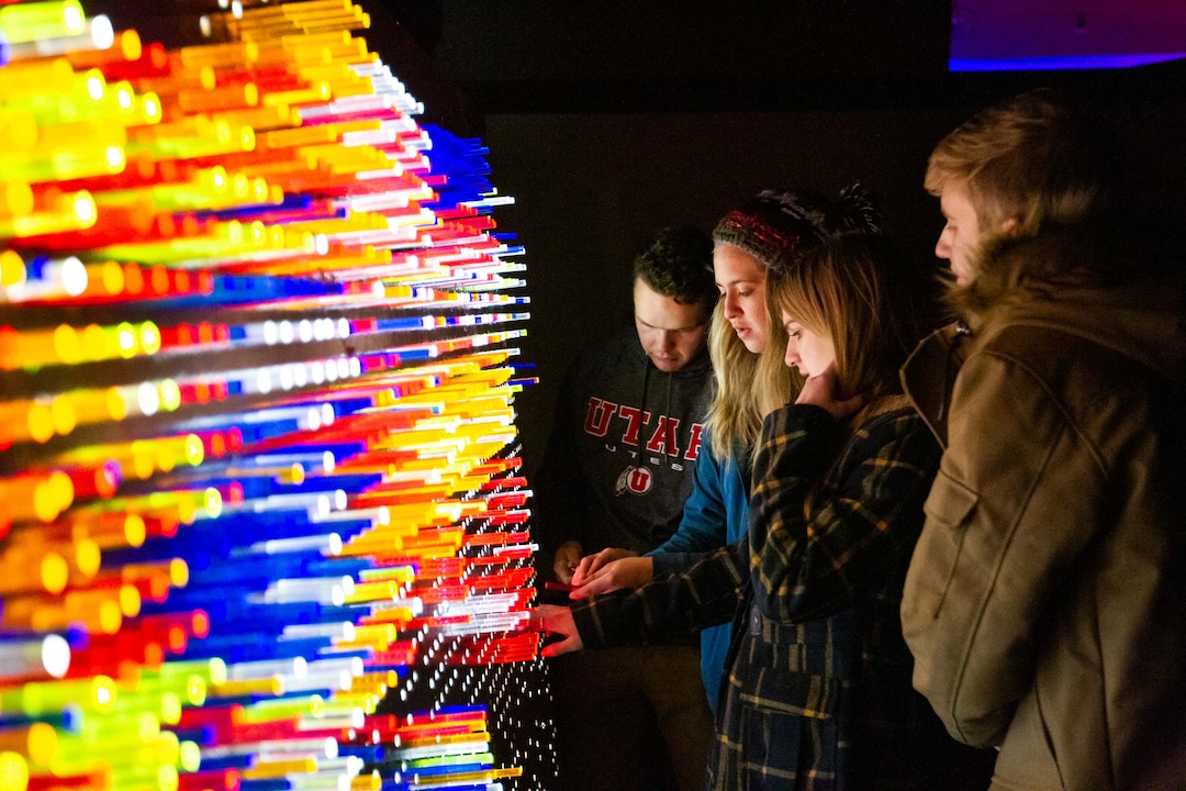 ( Farris Gerard | Courtesy of Utah Arts Alliance ) Guests at the 2018 Illuminate festival play with a board of lighted pegs at The Gateway.
