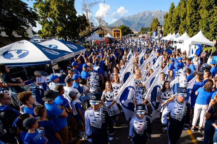 (Trent Nelson  |  The Salt Lake Tribune)  
The BYU Marching Band leads the Cougar Walk through the new Cougar Canyon tailgate area, as Brigham Young University (BYU) hosts the University of Utah, NCAA football in Provo on Thursday Aug. 29, 2019.