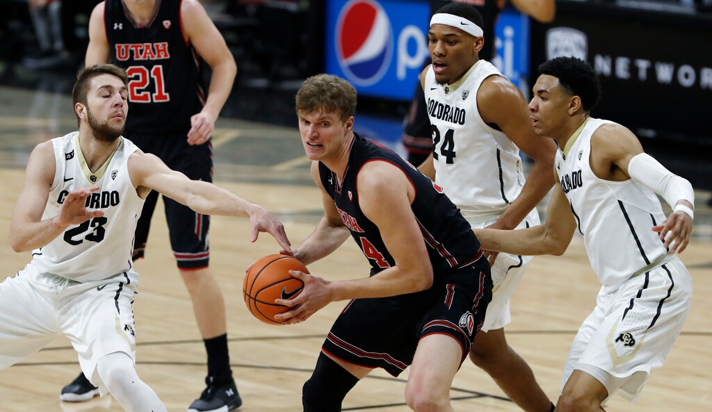 Utah forward Jayce Johnson pulls down a rebound as, from back left, Colorado forward Lucas Siewert and guards George King and Tyler Bey defend during the first half of an NCAA college basketball game Friday, Feb. 2, 2018, in Boulder, Colo. (AP Photo/David Zalubowski)