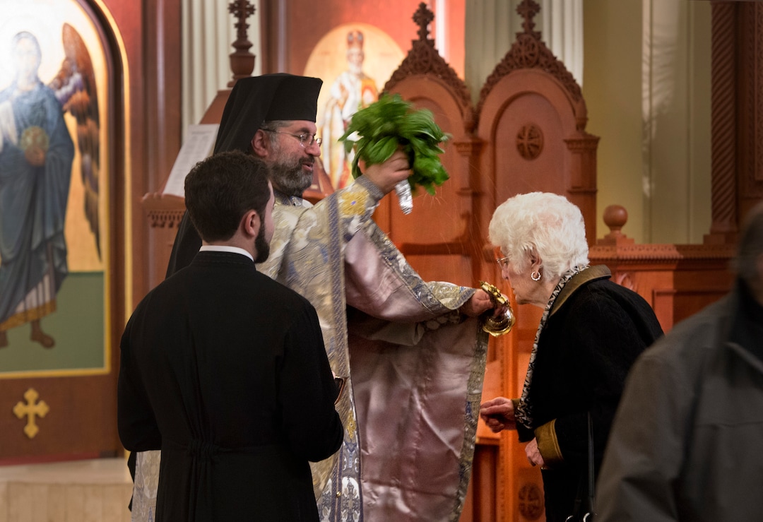(Scott Sommerdorf   |  The Salt Lake Tribune)   The Very Rev. Archimandrite George Nikas blesses congregants with holy water from a bouquet of basil as he conducts the Epiphany service (also called Theophany in Orthodox), as holy water is blessed, at Holy Trinity Cathedral, Saturday, January 6, 2018.