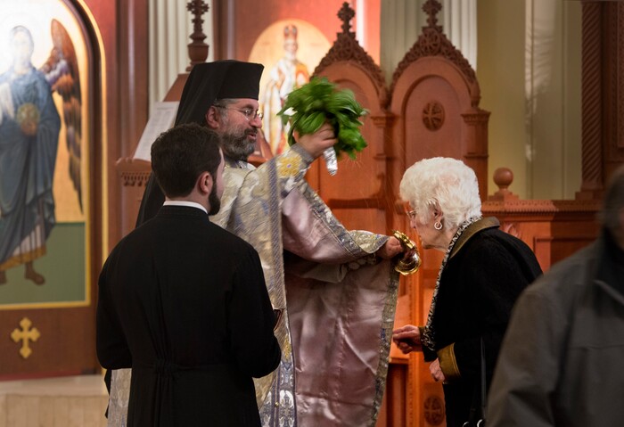 (Scott Sommerdorf | The Salt Lake Tribune)
The Very Rev. Archimandrite George Nikas blesses congregants with holy water from a bouquet of basil as he conducts the Epiphany service (also called Theophany in Orthodox), as holy water is blessed, at Holy Trinity Cathedral, Saturday, January 6, 2018.