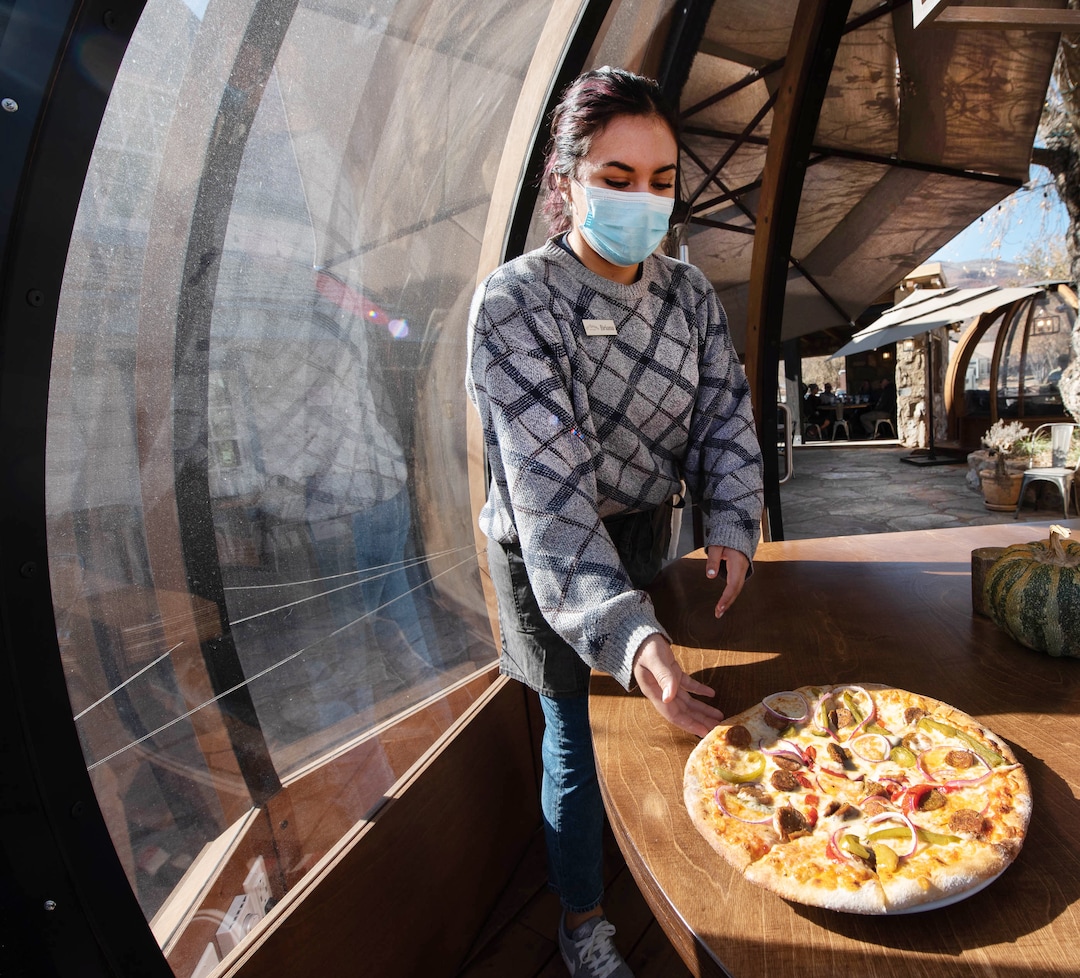 (Francisco Kjolseth  |  The Salt Lake Tribune) Briana Payan brings out a  Siciliana Italian sausage pizza to one of three dome-like Alpenglobes set up on the patio at Cafe Galleria in Midway on Thursday, Nov. 5, 2020.
