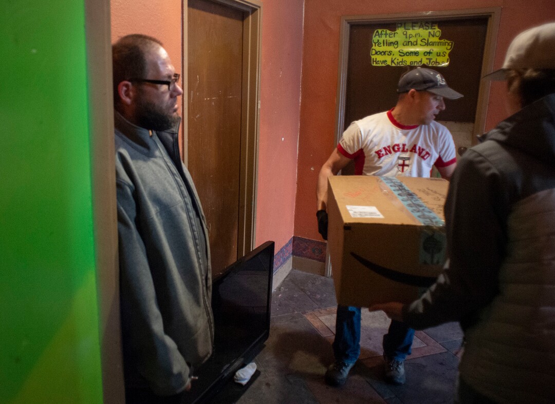 (Rick Egan | The Salt Lake Tribune)   Georgia apartment tentant, James Morrill, watches volunteers from a nearby church move items from his neighbor's apartment, hours before the police were scheduled to will come in and clear everyone out of the Georgia apartments.  Saturday, Feb. 16. 2019