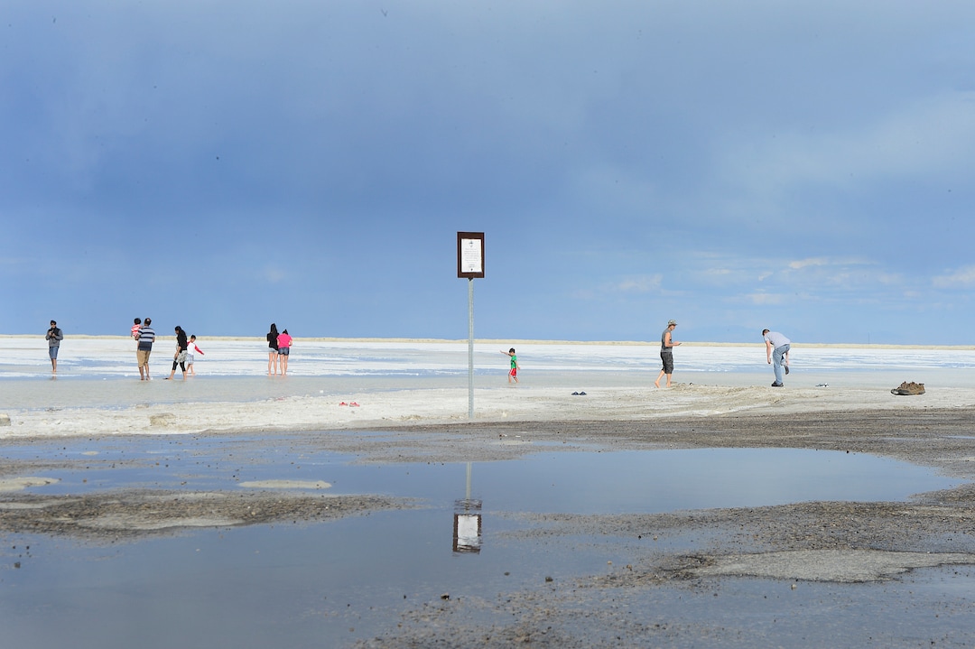 (Scott Sommerdorf   | Tribune file photo) Tourists walk on the flooded salt flats beyond one of the numerous signs warning motorists to stay off the salt flats near the Bonneville Speedway on Friday, May 27, 2016.