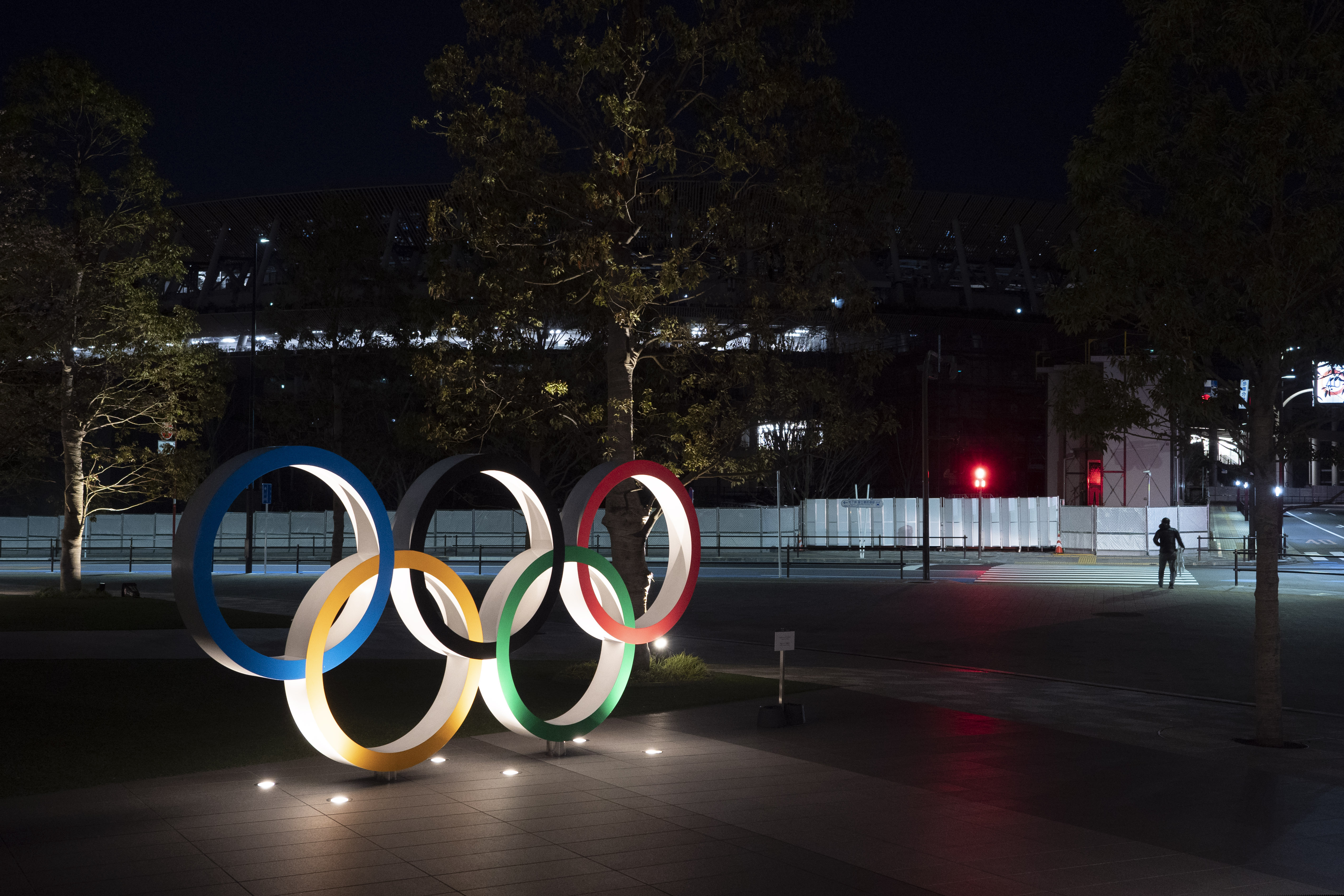 (Jae C. Hong | AP) The Olympic rings stand near the New National Stadium in Tokyo, Tuesday, March 24, 2020. IOC President Thomas Bach has agreed "100%" to a proposal of postponing the Tokyo Olympics for about one year until 2021 because of the coronavirus outbreak, Japanese Prime Minister Shinzo Abe said Tuesday.
