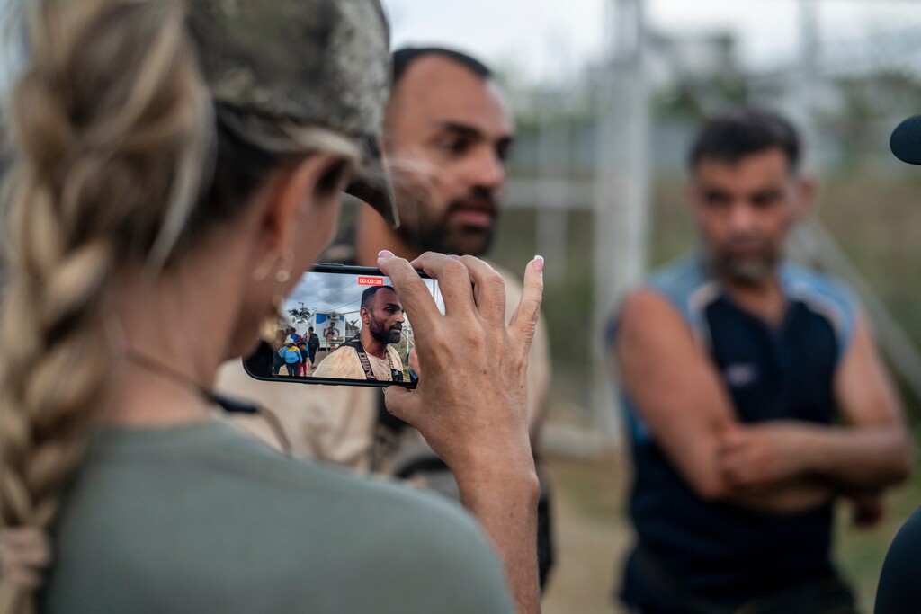 (Federico Rios | The New York Times) Ann Vandersteel, a podcaster in Florida who has traveled with Michael Yon, records an interview with Yazdan Faramehr, an Iranian migrant, at the San Vicente Migrant Reception Center, Panama, on Feb. 17, 2024. The treacherous migrant crossing in Panama is drawing packs of American activists who are distorting how immigration is perceived and debated at home.