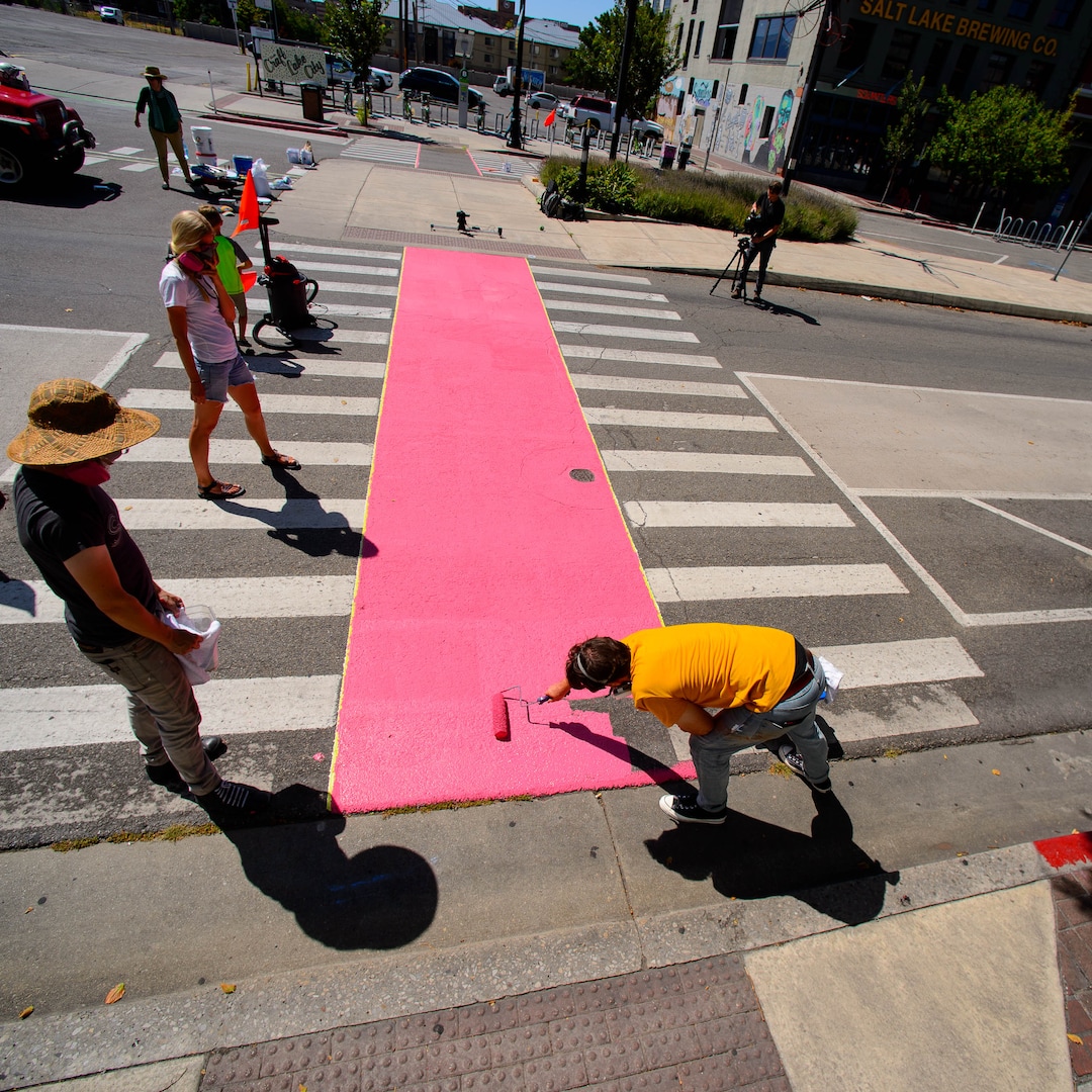 (Trent Nelson  |  The Salt Lake Tribune)  Tyler Bloomquist works on Jann Haworth's Rose art project on Broadway in Salt Lake City on Sunday Aug. 11, 2019.