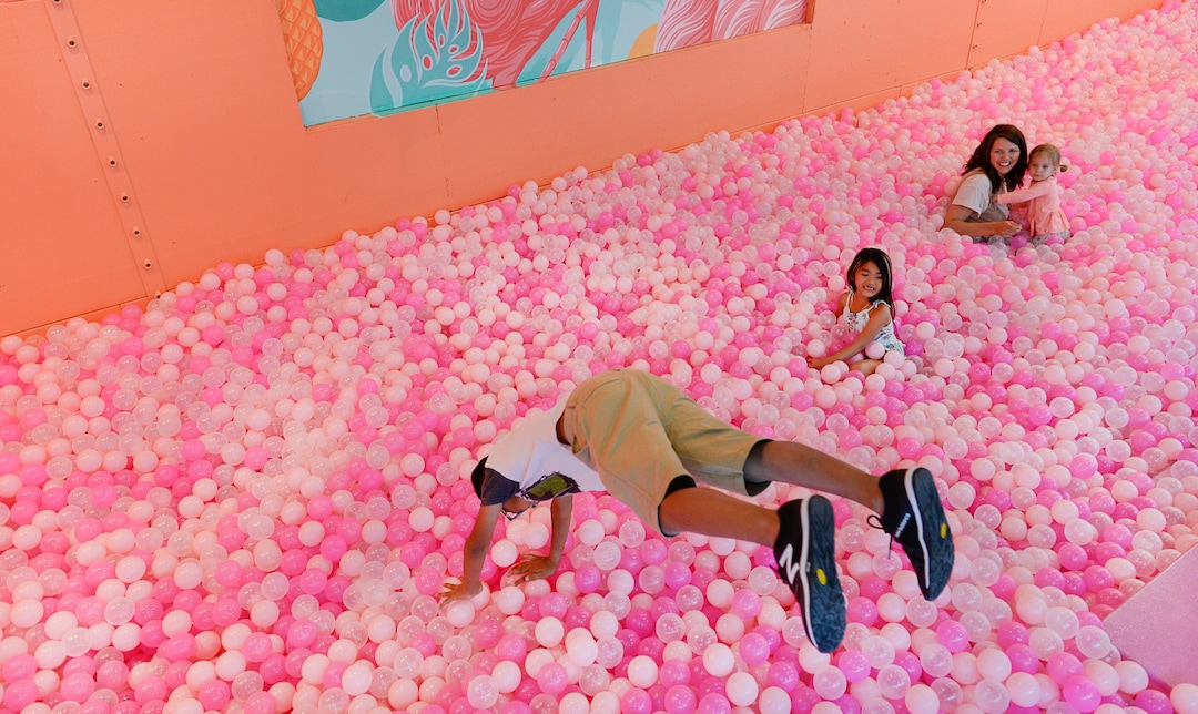 (Francisco Kjolseth  |  The Salt Lake Tribune)  Jaeden Thackin, 9, discovers the "giant neon fruit bowl" is shallower than expected at the Hall of Breakfast, a quirky new art exhibit that celebrates the first meal of the day. Each room celebrates a favorite breakfast food from eggs and bacon to cereal and coffee.