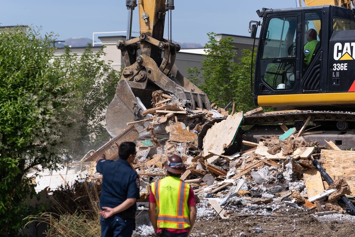 (Francisco Kjolseth | The Salt Lake Tribune) South Jordan tears down a house where an owner kept a stockpile of explosives, as firefighters help burn off residual explosives that remained in the basement of the home and could not be safely removed on Tuesday, June 1, 2021.