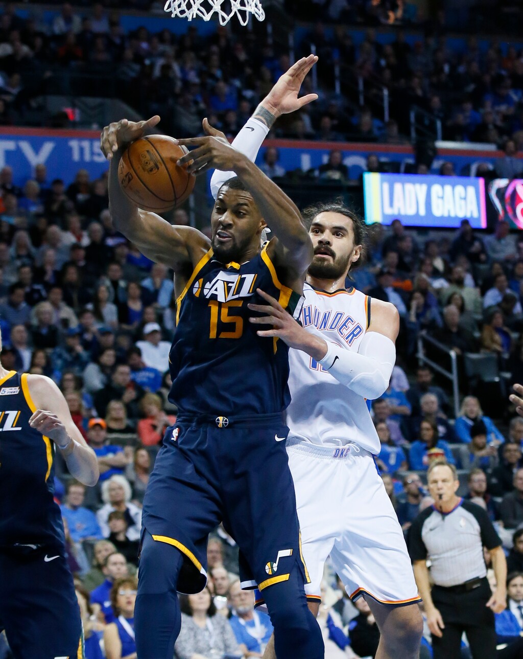 Utah Jazz forward Derrick Favors (15) grabs a rebound in front of Oklahoma City Thunder center Steven Adams, right, in the second quarter of an NBA basketball game in Oklahoma City, Tuesday, Dec. 5, 2017. (AP Photo/Sue Ogrocki)