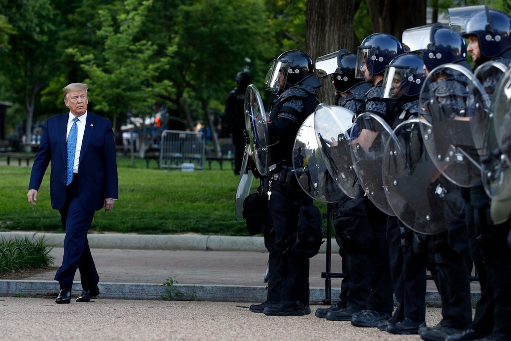 (Patrick Semansky | AP file photo) President Donald Trump walks past police in Lafayette Park after he visited outside St. John's Church across from the White House Monday, June 1, 2020, in Washington. Part of the church was set on fire during protests on Sunday night.
