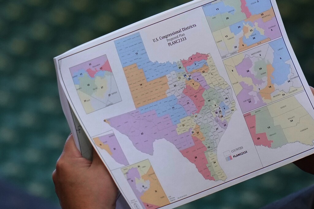 Texas state Sen. Pete Flores, R-Pleasanton, looks over a redrawn U.S. congressional map during debate over a bill in the Senate Chamber at the Texas Capitol in Austin, Texas, Friday, Aug. 22, 2025. (AP Photo/Eric Gay)