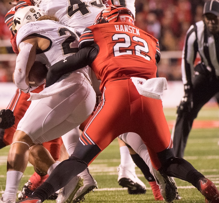 Utah Utes defensive back Chase Hansen (22) Colorado Buffaloes running back Phillip Lindsay (23) for a loss, in PAC-12 football action Utah Utes vs. Colorado Buffaloes at Rice-Eccles stadium, Saturday, November 25, 2017.
