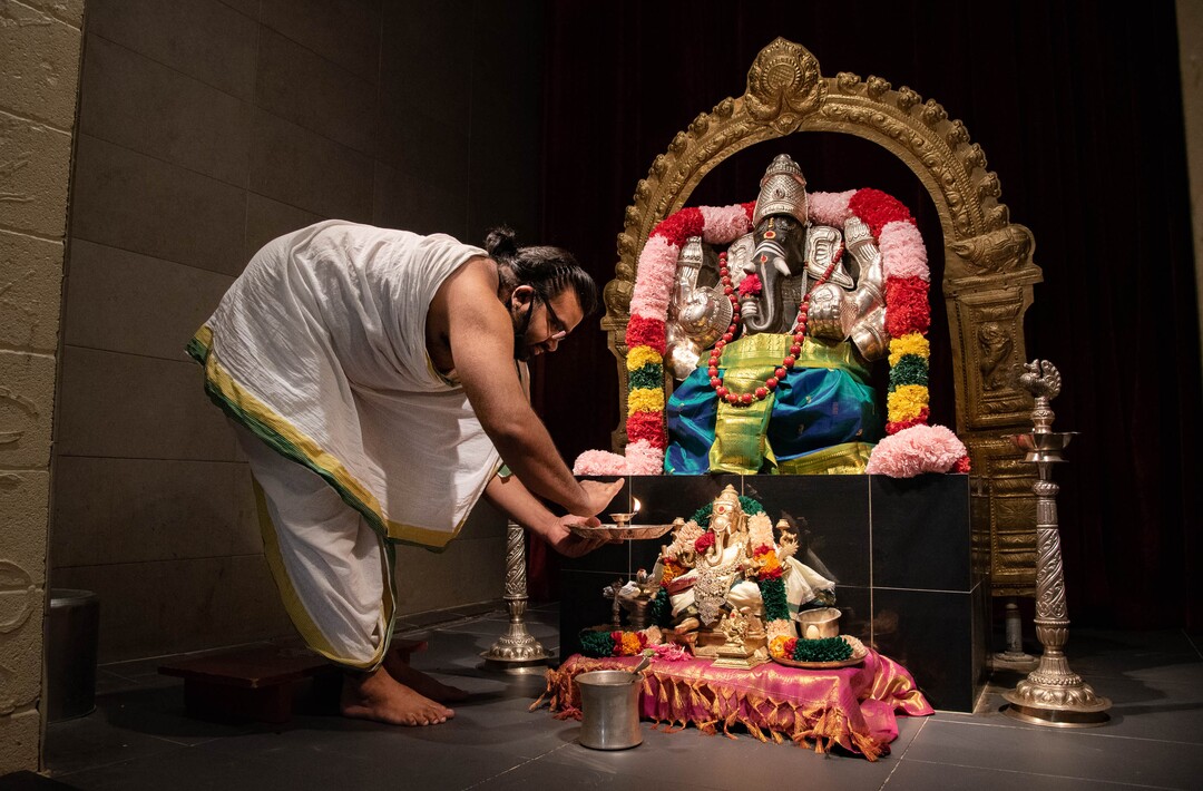 (Francisco Kjolseth  |  The Salt Lake Tribune) Hindu priest Sathish Nivarthi performs a fire ceremony on the shrine of Ganesha which represents light and warmth and the lighting of knowledge in our minds, at the Sri Ganesha Hindu Temple in South Jordan on Thursday, Sept. 26, 2020. As a way tp stay safe and cope during COVID-19, the temple is closed during weekdays, but priests go in in the evenings to decorate the statues and give offerings while broadcasting live classes and services online.