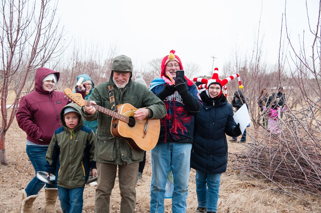 (Ann Torrence) Wassailers scare the evil spirts out of the orchard at Etta Place Cider by clanging pots and pans, tooting horns and marching among the apple trees on Saturday, Jan. 13, 2024.