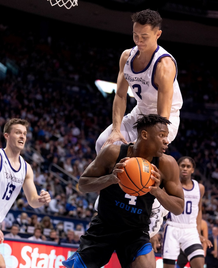 (Francisco Kjolseth | The Salt Lake Tribune) Westminster Griffins guard Taylor Miller (3) goes up for a block prematurely over Brigham Young Cougars forward Atiki Ally Atiki (4) in basketball action between the Brigham Young Cougars and the Westminster Griffins at the Marriott Center in Provo, Wednesday, Dec. 29, 2021.